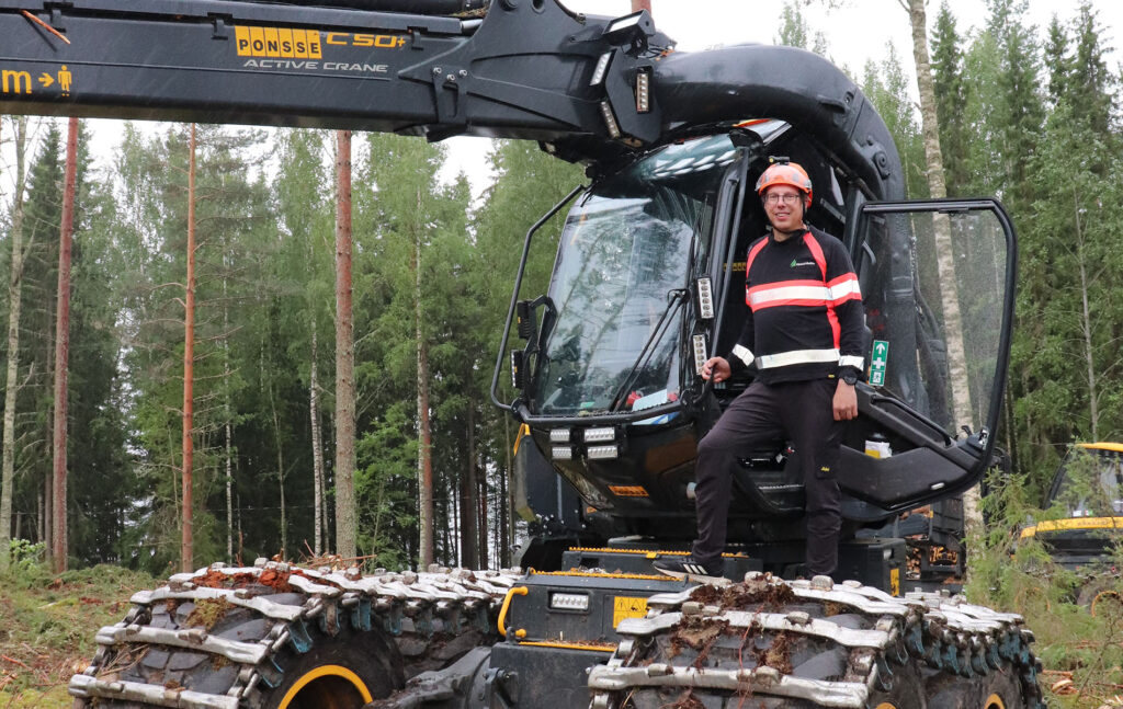 Marko Hauta-Aho poseeraa traktorin vieressä.