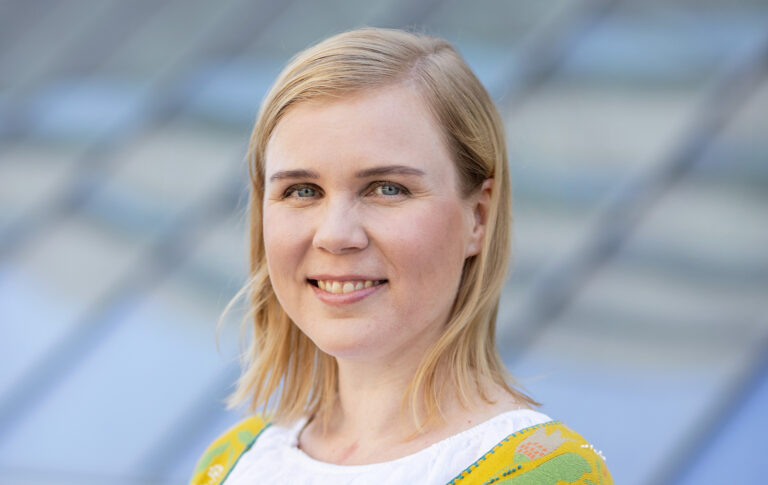 Elina Warsta katsoo kohti kameraa.